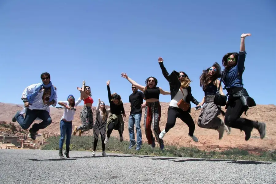 A small group jumping for joy in the Todra Gorge